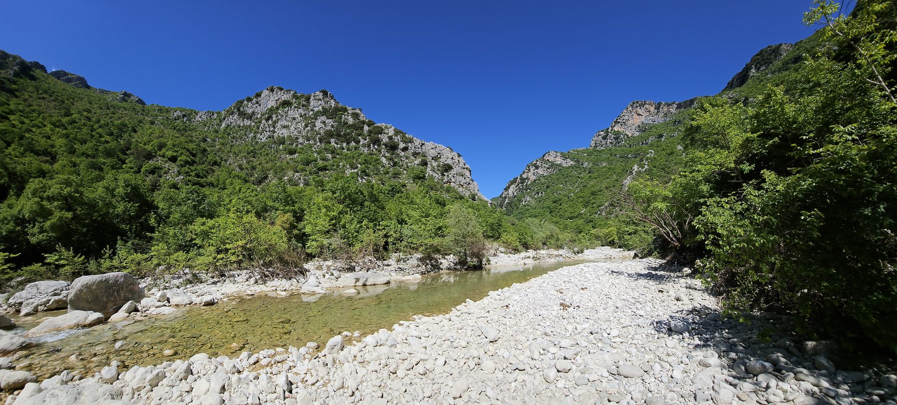 A green valley with a wide riverbed